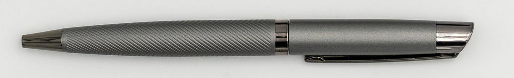 Stylo en métal gris avec partie supérieure lisse et corps à lignes diagonales.