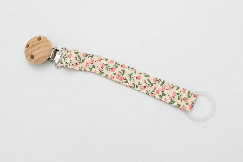 Attache-tétine en tissu à petites fleurs roses, feuilles vertes et clip rond en bois